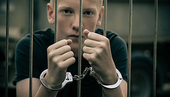 teenager arrested in handcuffs