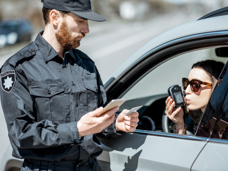 woman conducting a breathalyzer test