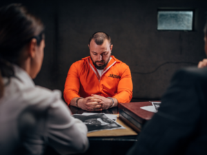 felon sitting at a table in jail